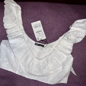 ZARA white eyelet/ ruffle crop top. Ruffle can be worn on or off shoulder.